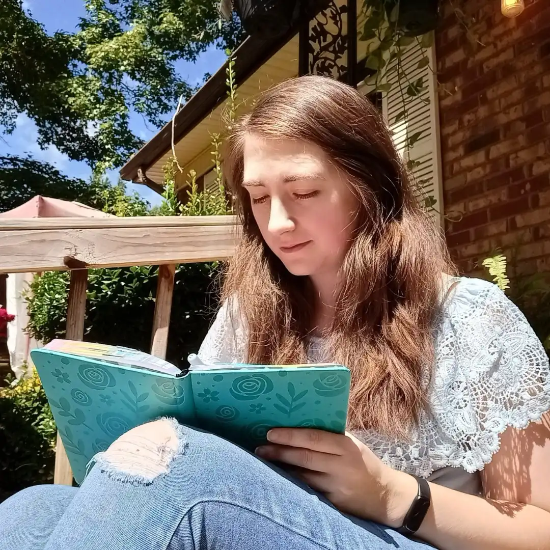 A photo of Tess, owner of Perk and Pause doing a bit of journaling.